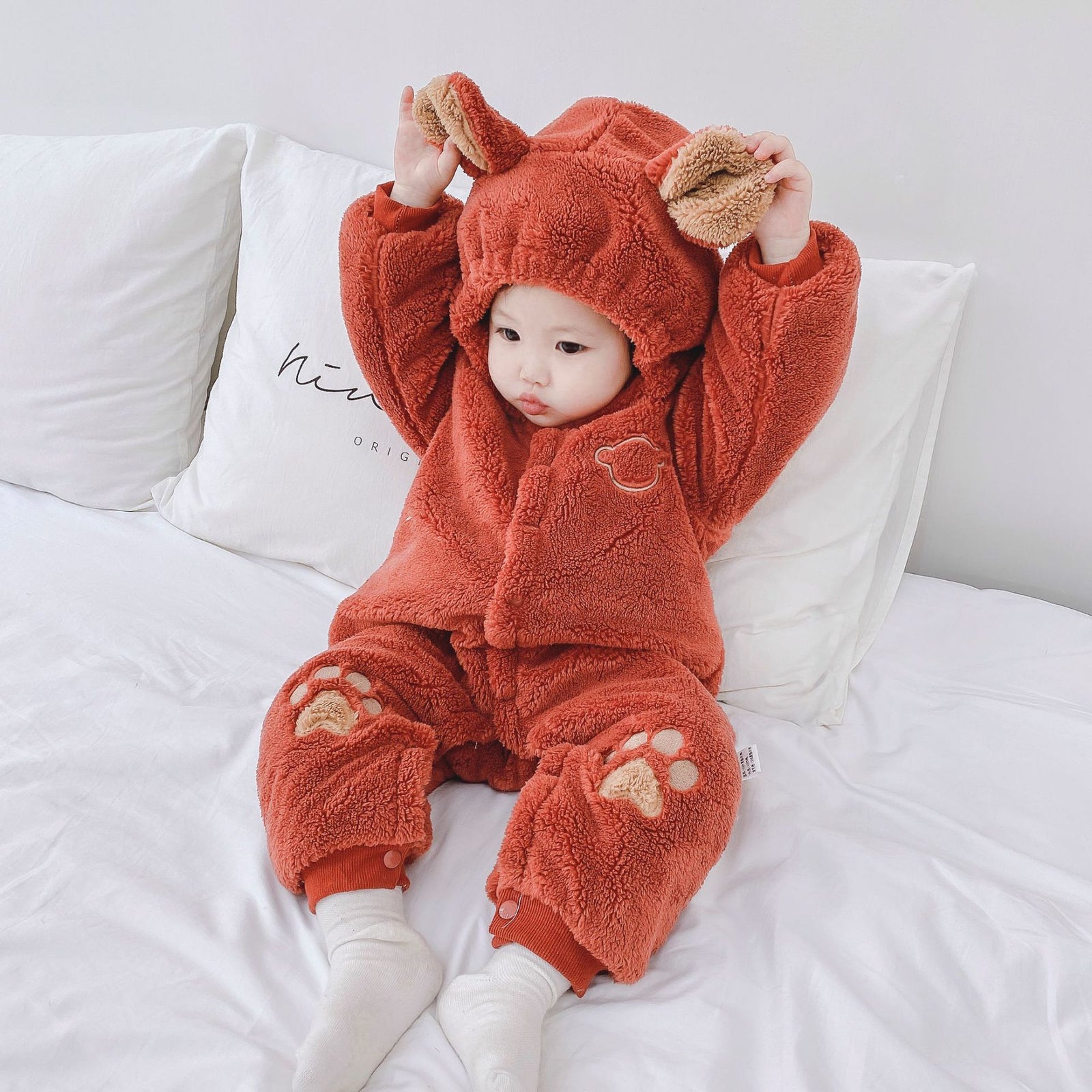 Adorable baby bear romper in soft brown fleece with hood and paw prints on knees for infants