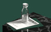 Homeshinex portable electric juicer blender in clear design placed on magazine on black marble table