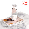 Homeshinex portable electric juicer blender in clear bottle design on marble surface with magazines