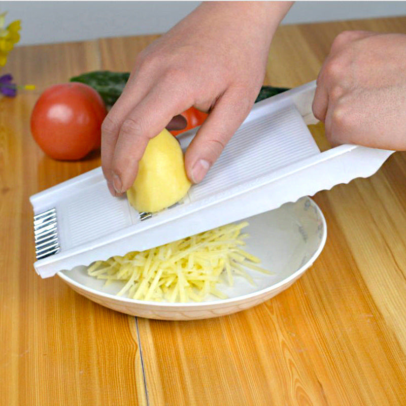 Homeshinex multifunctional kitchen grater with hand grating potato over bowl on wooden table