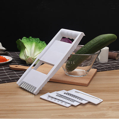 Homeshinex multifunctional kitchen grater with interchangeable blades and handle on wooden table