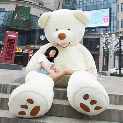 Homeshinex soft leather teddy bear toy large plush sitting outdoors with woman resting on it