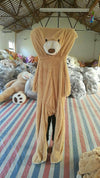 Homeshinex soft leather teddy bear toy costume displayed in a warehouse with striped flooring