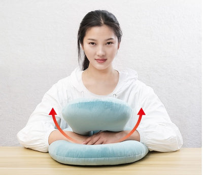 Homeshinex baby travel neck pillow with arm rest in light blue held by woman wearing white shirt